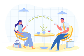Two people sitting at the table sending money to each other through their mobile phones