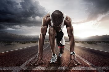 A running athlete at the start line, seconds before the gun fires